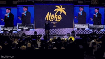 Stage presentation showing four screens with simultaneous offline translations in Chinese, Bahasa Indonesia, English, and Thai